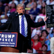 Donald Trump holds up a sign printed from the internet at a rally in Sunrise, Florida on August 10, 2016 (AP Photo/Evan Vucci)